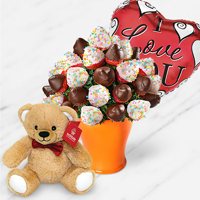 arrangement of chocolate dipped strawberries in a vase, teddy bear, and heart shaped balloon that says &quot;I Love you&quot;