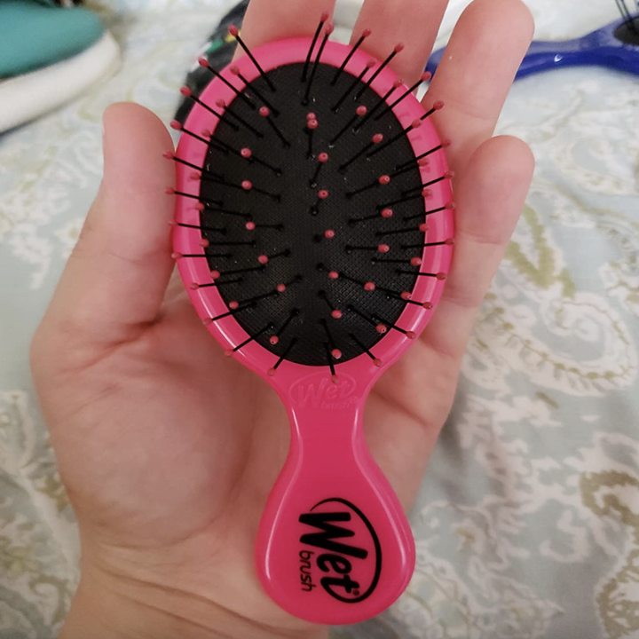 reviewer holding the pink brush