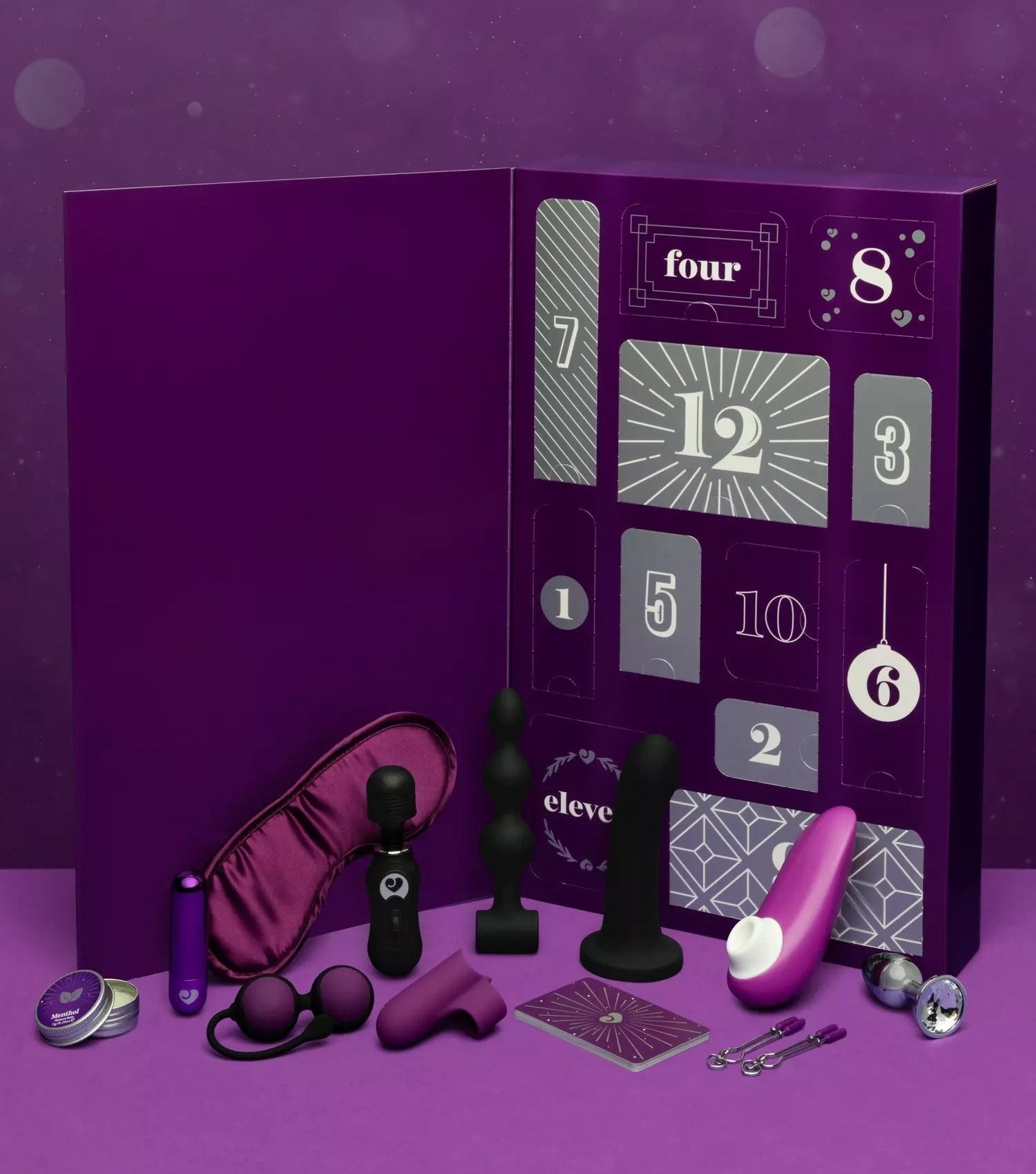 Purple advent calendar surrounded by purple and black sex toys and accessories