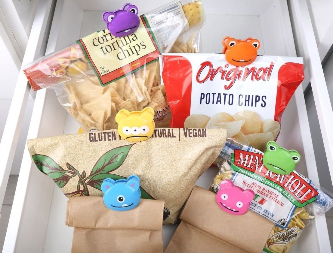 a snack drawer with each bag of snacks clasped closed with monster-shaped clips