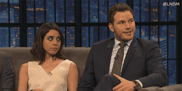 Aubrey Plaza sits on a couch and rolls her eyes as she leans her head back while Chris Pratt sits beside her and smiles in &quot;Late Night with Seth Meyers&quot;