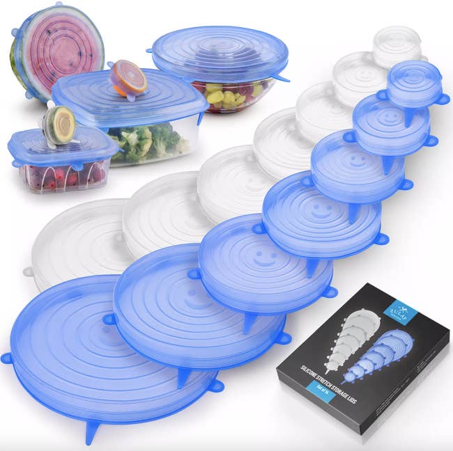 A set of seven clear lids and seven blue lids spread out to show varying sizes. As well as a lids over half a watermelon, half an avocado, half an orange, and three separate containers in the left corner.