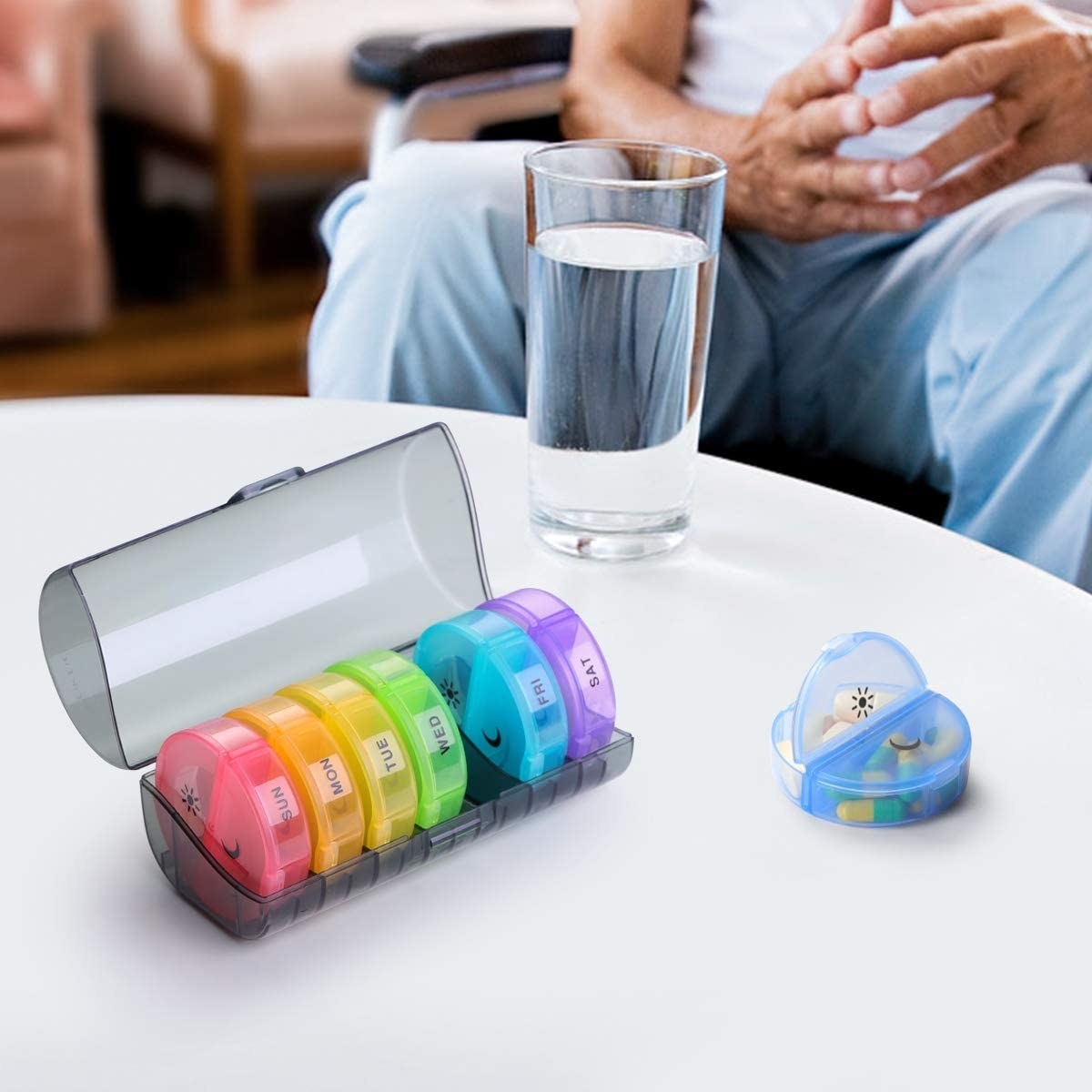 a tubular pill organizer with separate discs for each day of the week