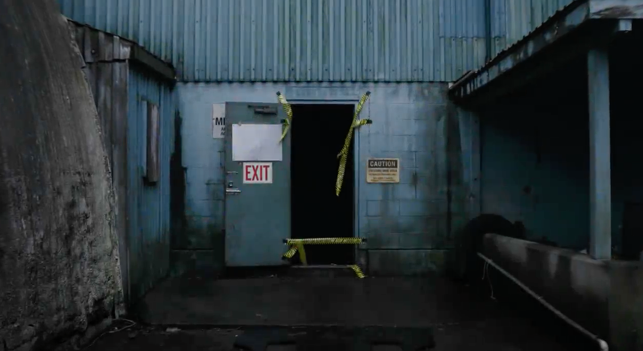 An open doorway to an abandoned mine, dark inside