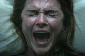 A woman screaming in bed