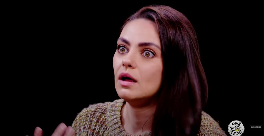 Mila Kunis looking shocked during her Hot Ones interview