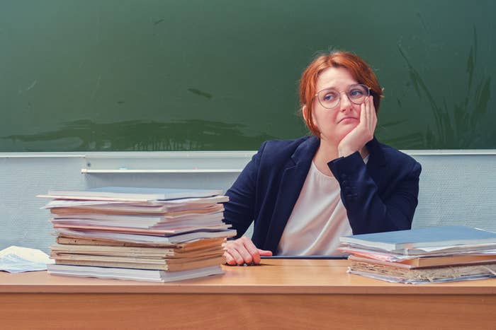 A sad teacher at her desk
