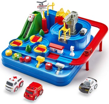 The race track next to a toy ambulance, a firetruck and a police car