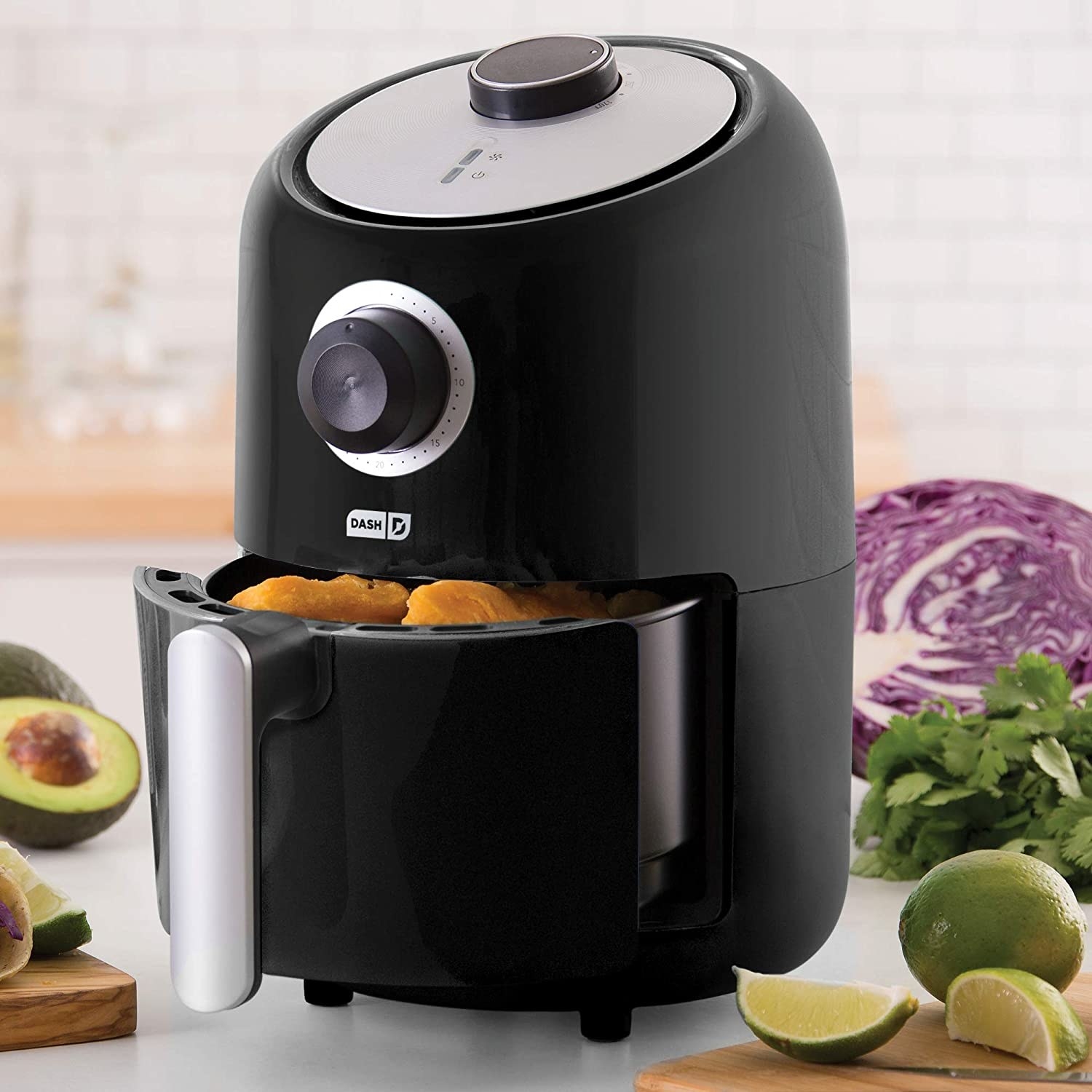 The air fryer in black, featuring an analog timer, round temperature dial, and convenient handle for removing the basket
