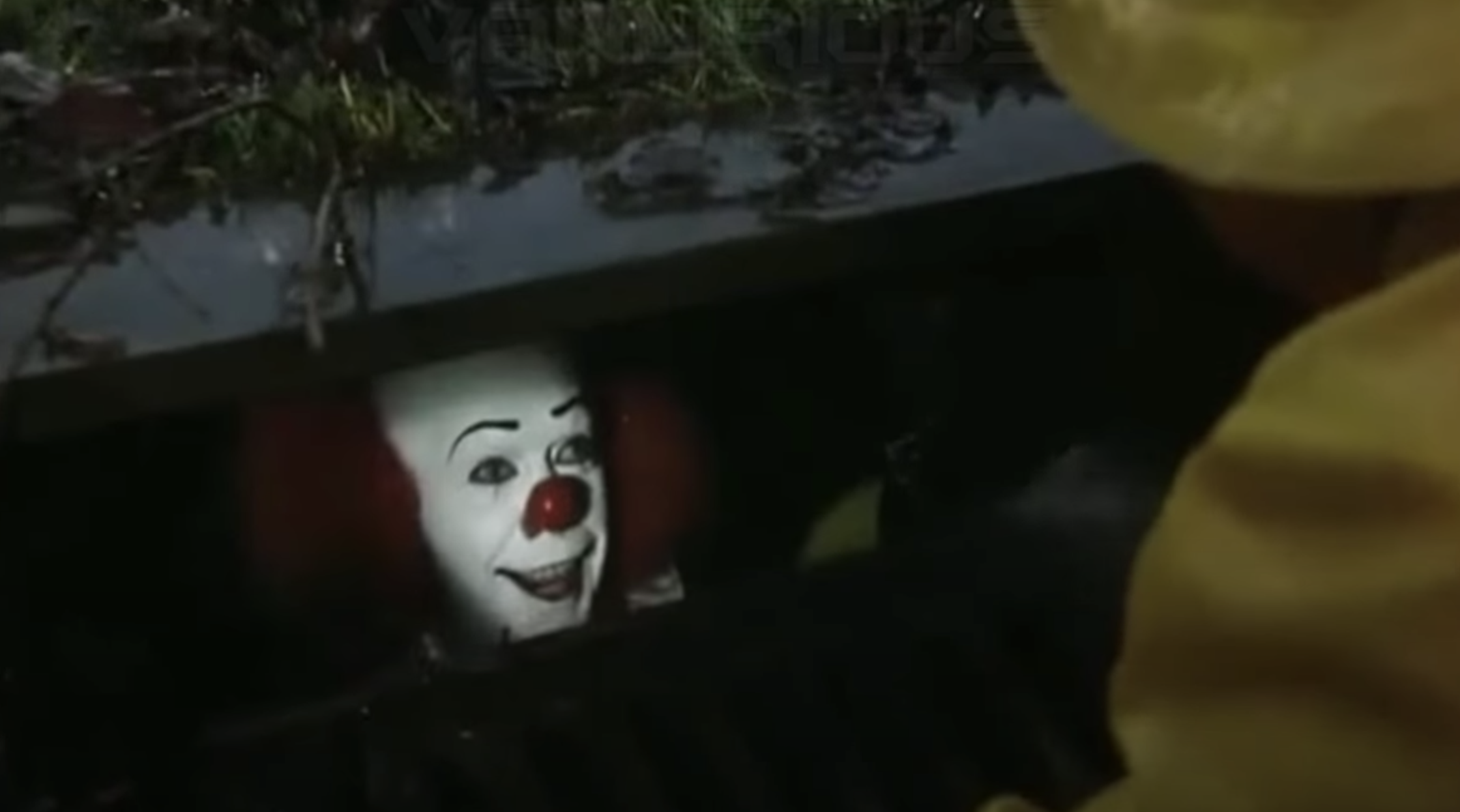It the clown smiles at a boy from a storm drain