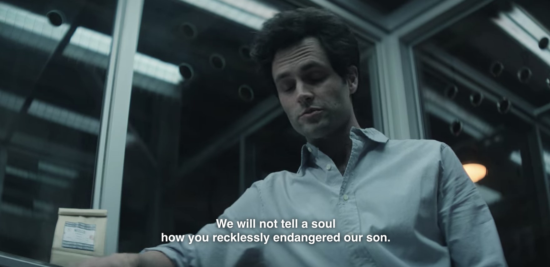 Joe (Penn Badgley)  talks to Gil, who is offscreen. The caption of what he says reads, We will not tell a soul how you recklessly endangered our son