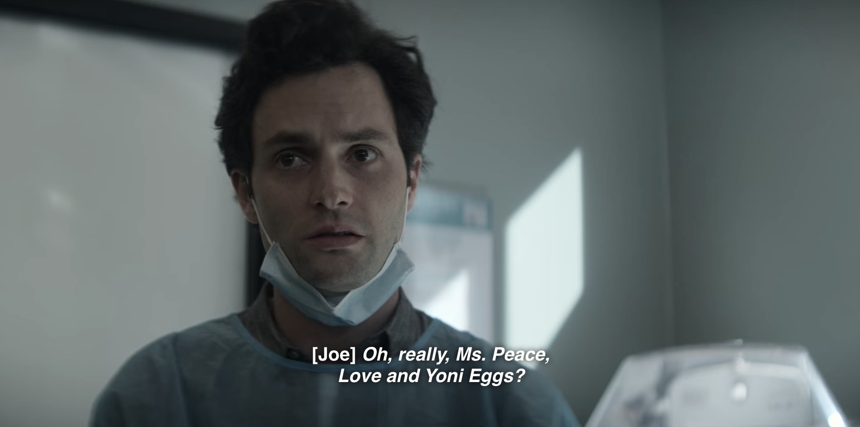 Joe (Penn Badgley)  looks annoyed. Caption of his thoughts reads, Oh, really Ms. Peace, Love and Yoni Eggs