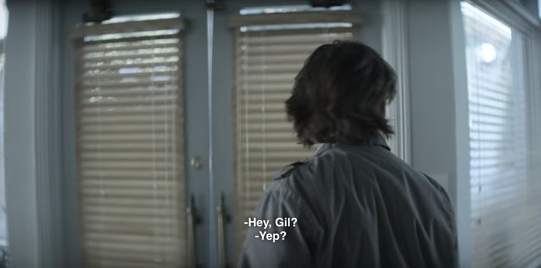 Gil has turned away from the screen with the back of his head aimed at us. The caption of what Love ( who is offscreen) is saying to him reads, &quot;Hey, Gil?&quot; The Caption of what Gil replies is Yep