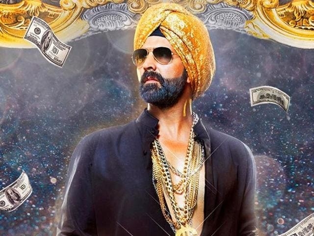 Bollywood actor Akshay Kumar wearing a black shirt, gold chains and a gold turban for the movie poster of Singh is Bling.