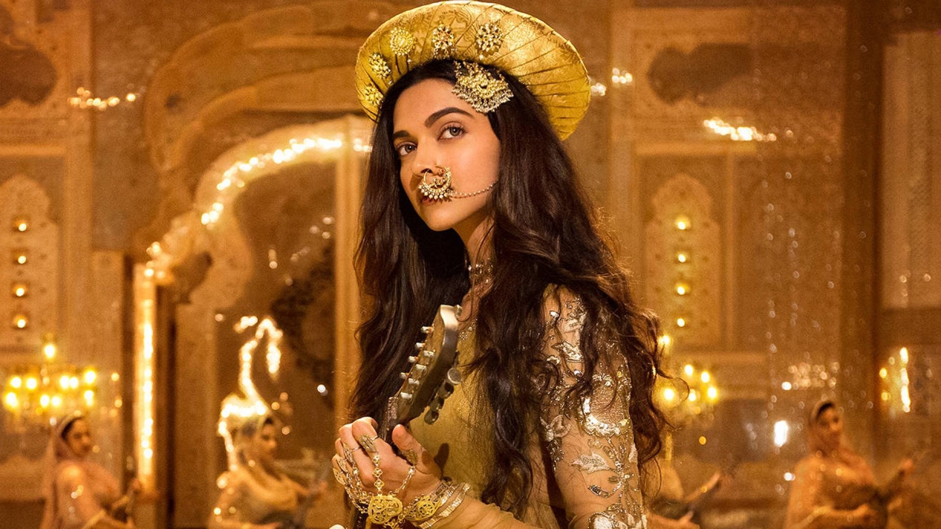Deepika Padukone dressed in a Golden Lehenga and a turban with a nose ring, as her character Mastani for the movie Bajirao Mastani.