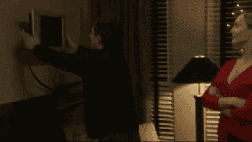 Michael pushing his plasma TV against the wall