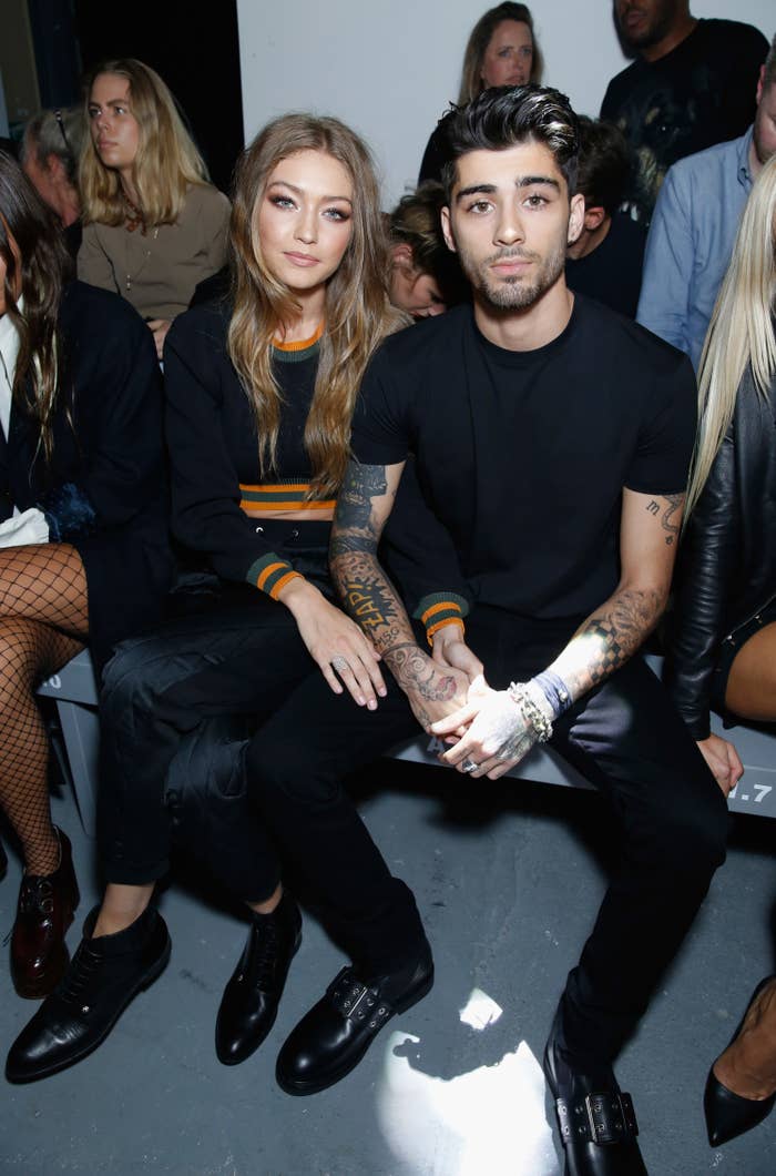 Gigi and Zayn sit next to each other at a fashion event