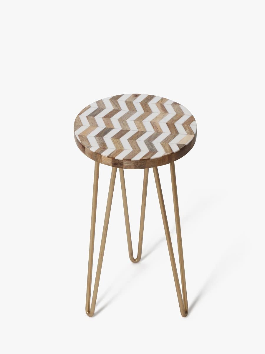 A table with golden hairpin legs and a chevron design on the top