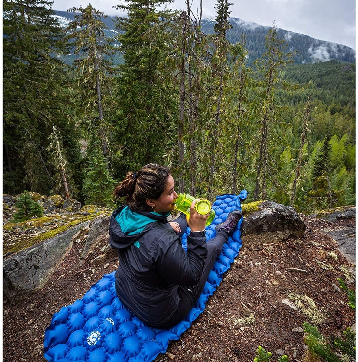 A person sitting on the sleeping pad