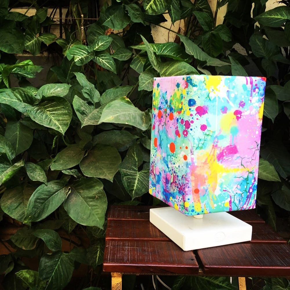 A cuboid-shaped lamp with watercolour-style splatters on it