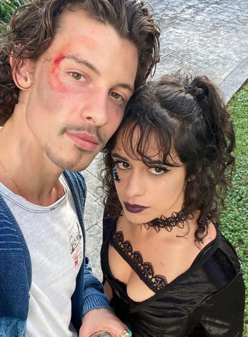 A close up of Shawn Mendes with a wound on his forehead and Camila Cabello as she wears a dark lace dress and matching choker