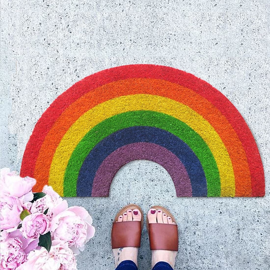 A rainbow mat with a woman&#x27;s feet near it
