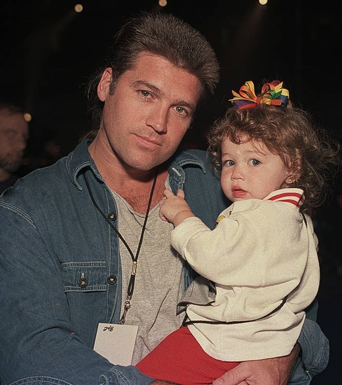 Billy Ray holding baby Miley at an event in 1994
