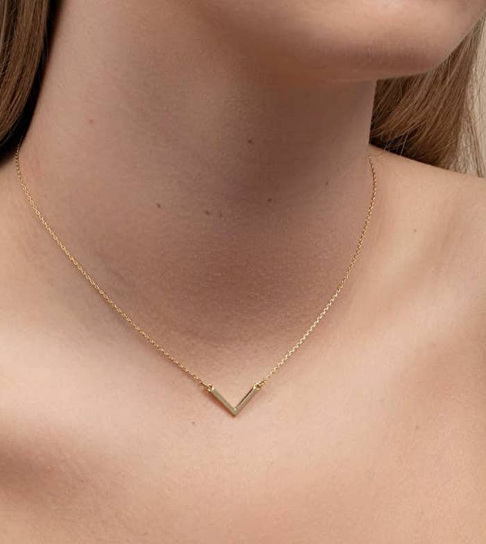 model wearing baby v necklace