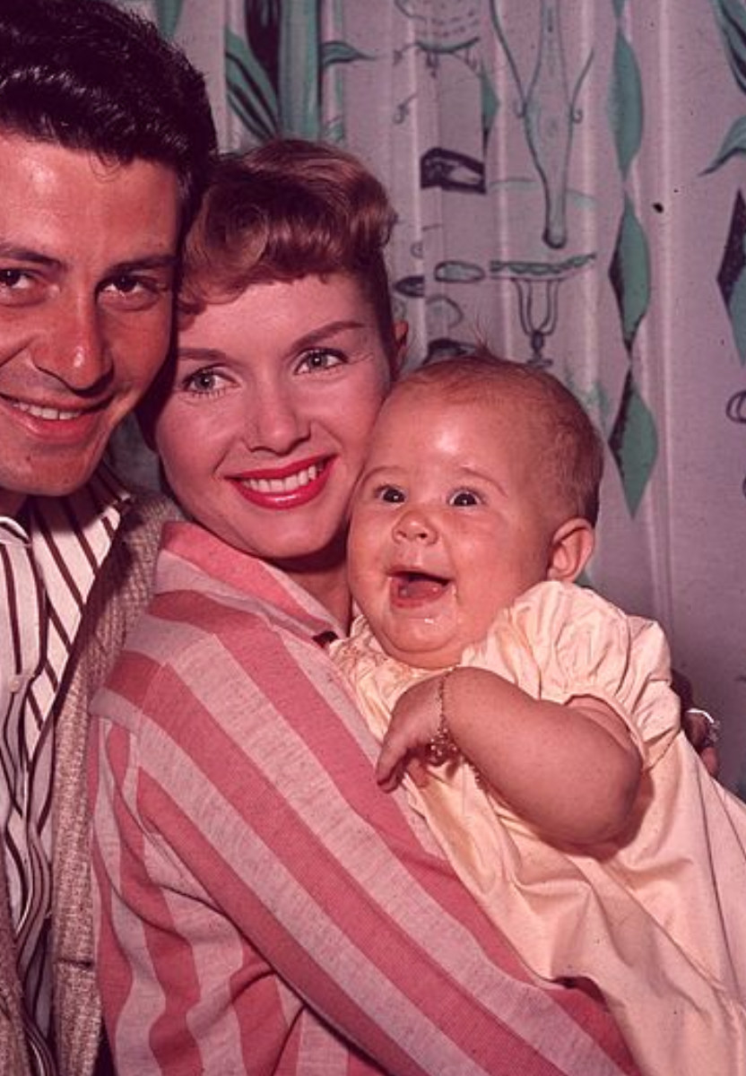 Reynolds holding Fisher as a baby in the late 1950s