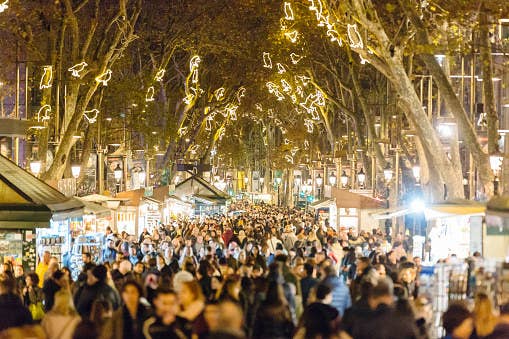 A crowd holiday shopping at a night market.