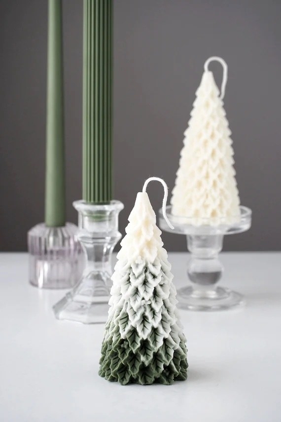 The snow capped tree candle in the foreground with an undyed tree candle in the background