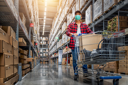 A man shops in a warehouse store.