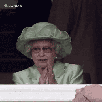 Queen Elizabeth applauding at a cricket match