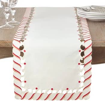 The candy cane table runner hanging over a table