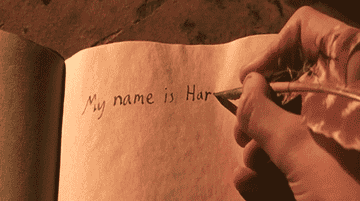 GIF of hand writing &quot;My name is Harry&quot; in a booklet