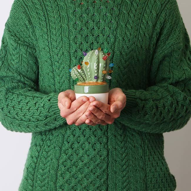 Model holding the ceramic cactus