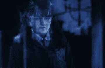 Moaning Myrtle looking at a sink in the prefect&#x27;s bathroom