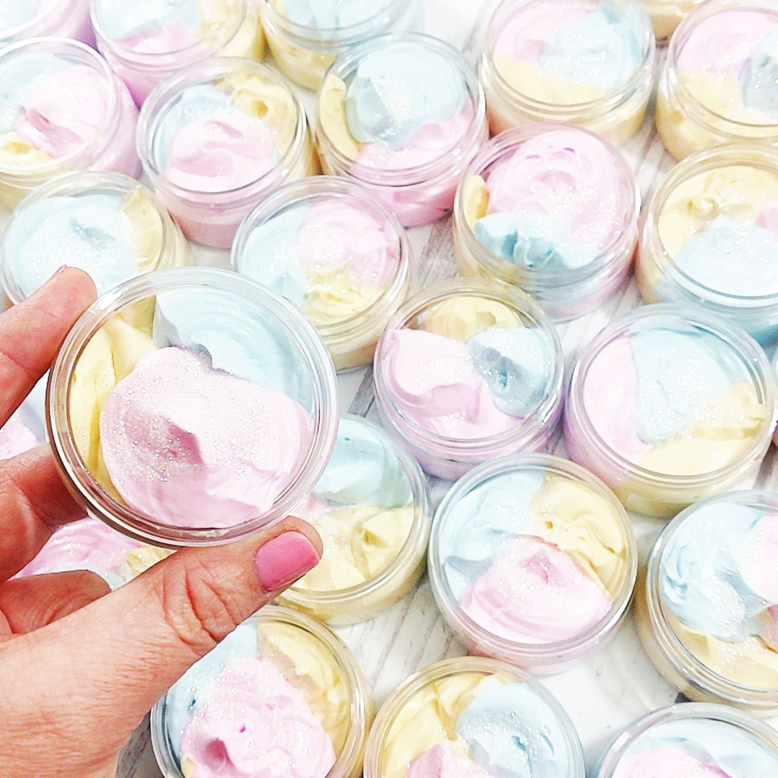 Mini jars containing the rainbow colored whipped cream