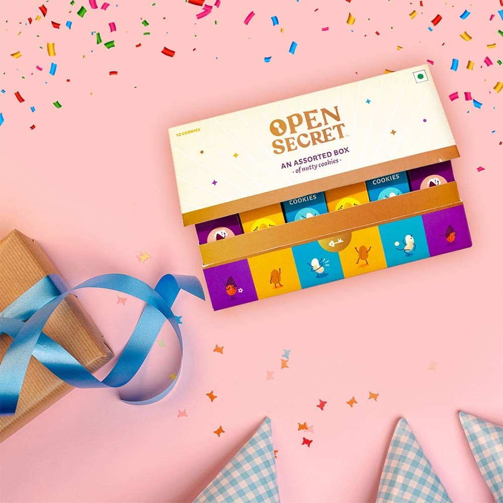 Cookies in a box next to ribbons and handkerchiefs