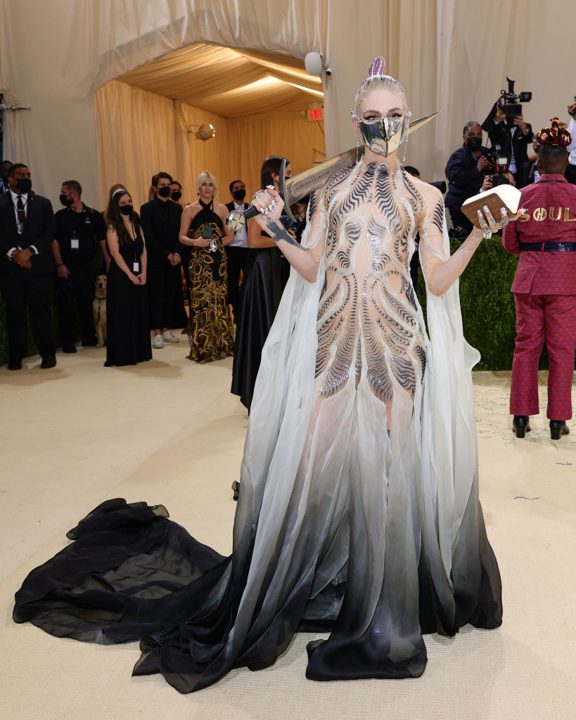 Grimes in an elaborate costume with a mask