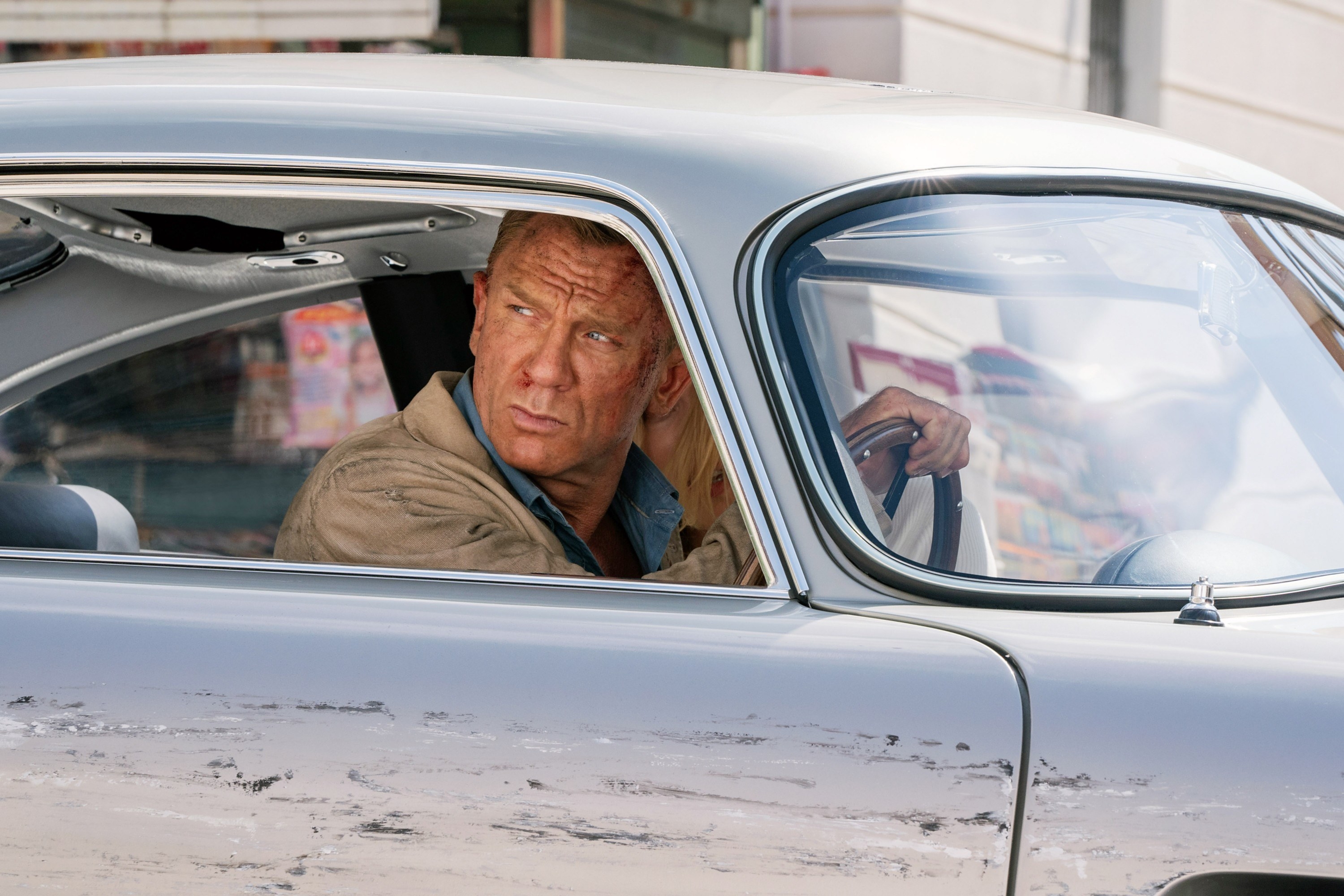 Daniel as Bond behind the wheel of a car