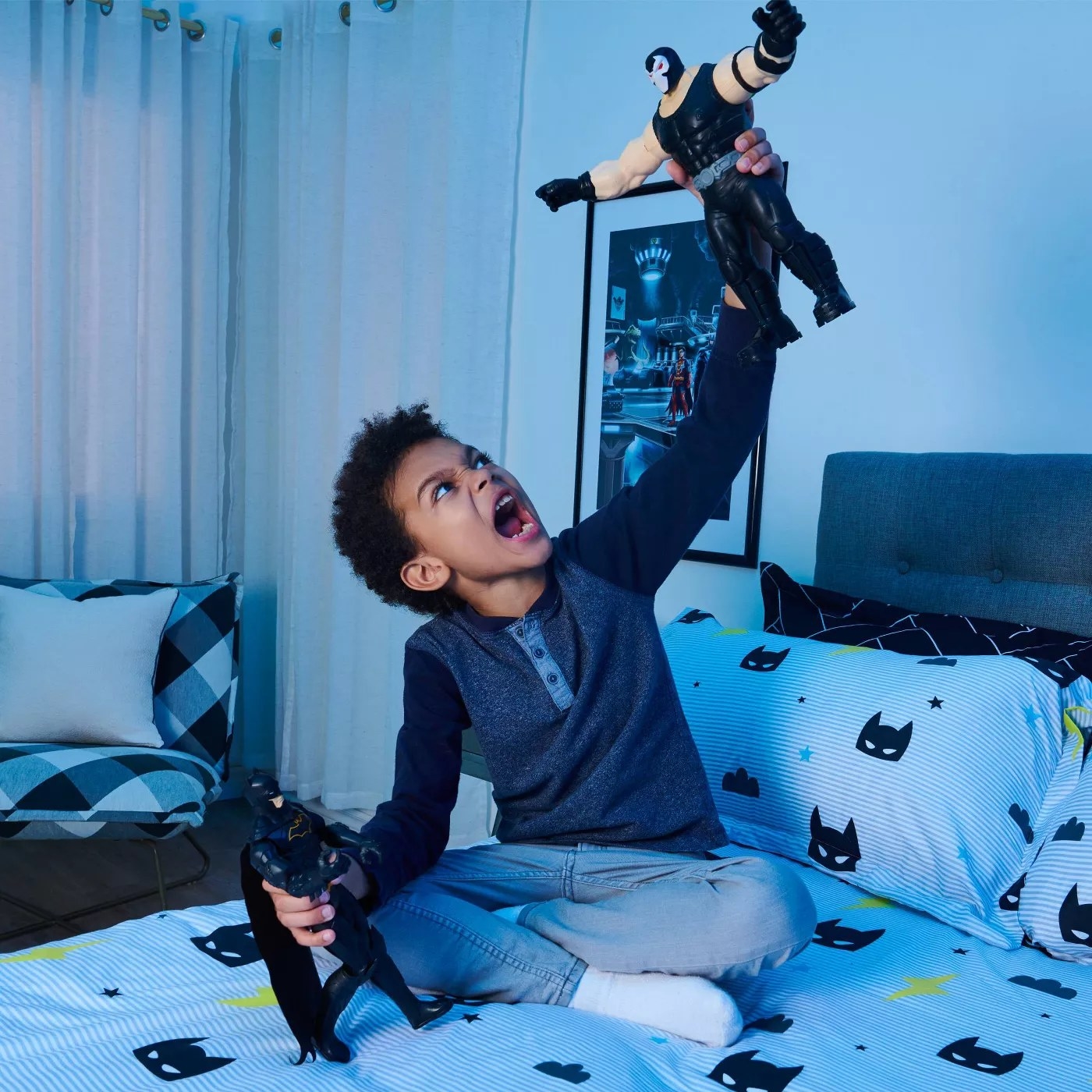 A child playing with the Batman and Bane action figures