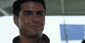 GIF of Tom Cruise smiling and putting on shades