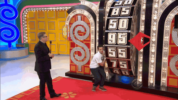 GIF of The Price Is Right with Drew Carey as a person tries hanging on the wheel