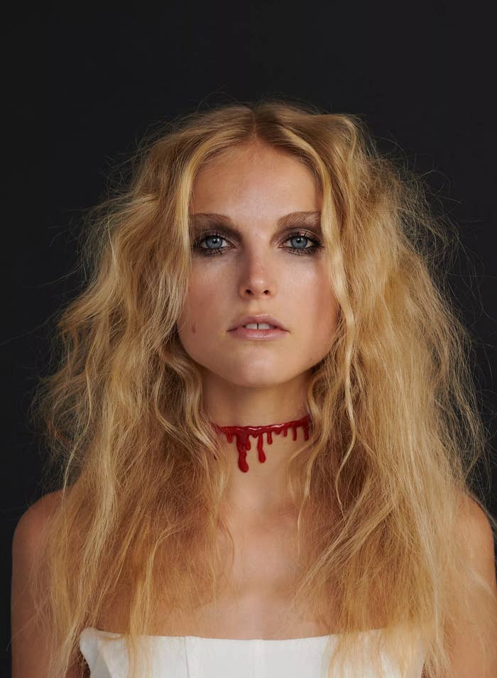 A person wearing a choker necklace that looks like dripping blood