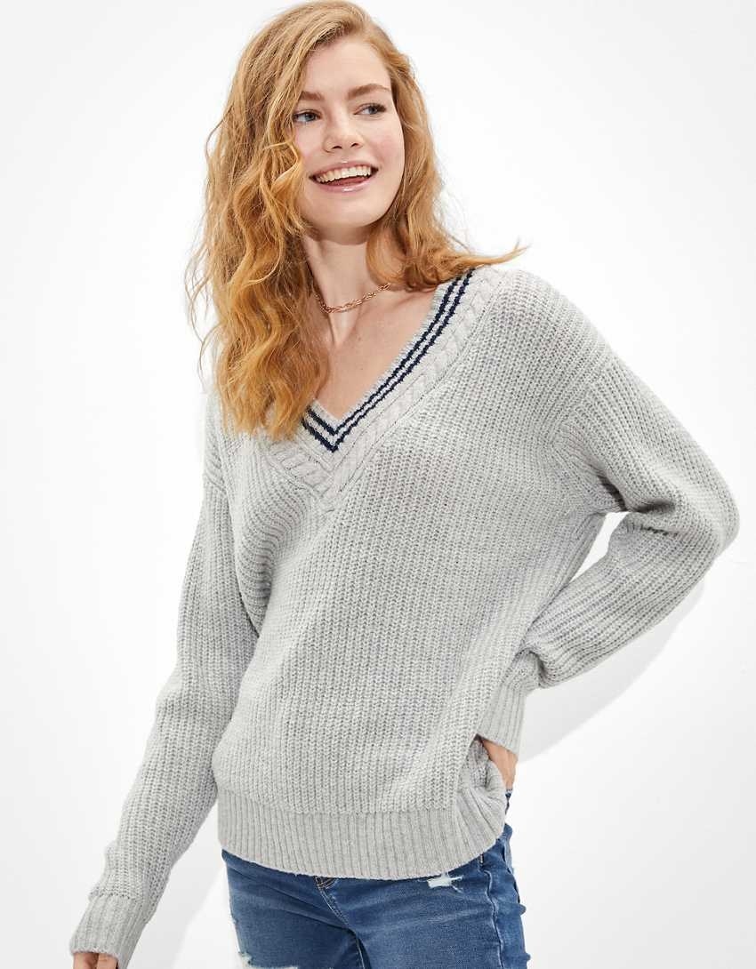 A model wearing a grey v neck sweater