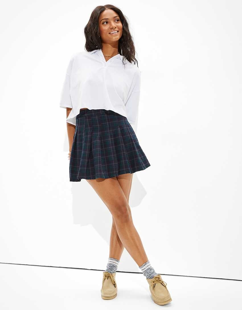 A model wearing a plaid pleated skirt