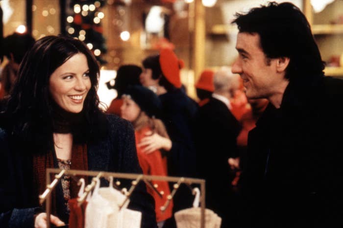 Kate Beckinsale and John Cusack look at each other in a holiday setting in the film Serendipity