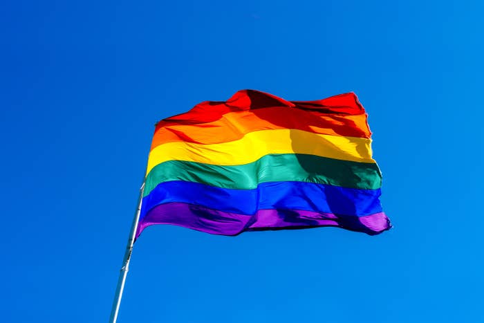 A rainbow pride flag blowing in the wind