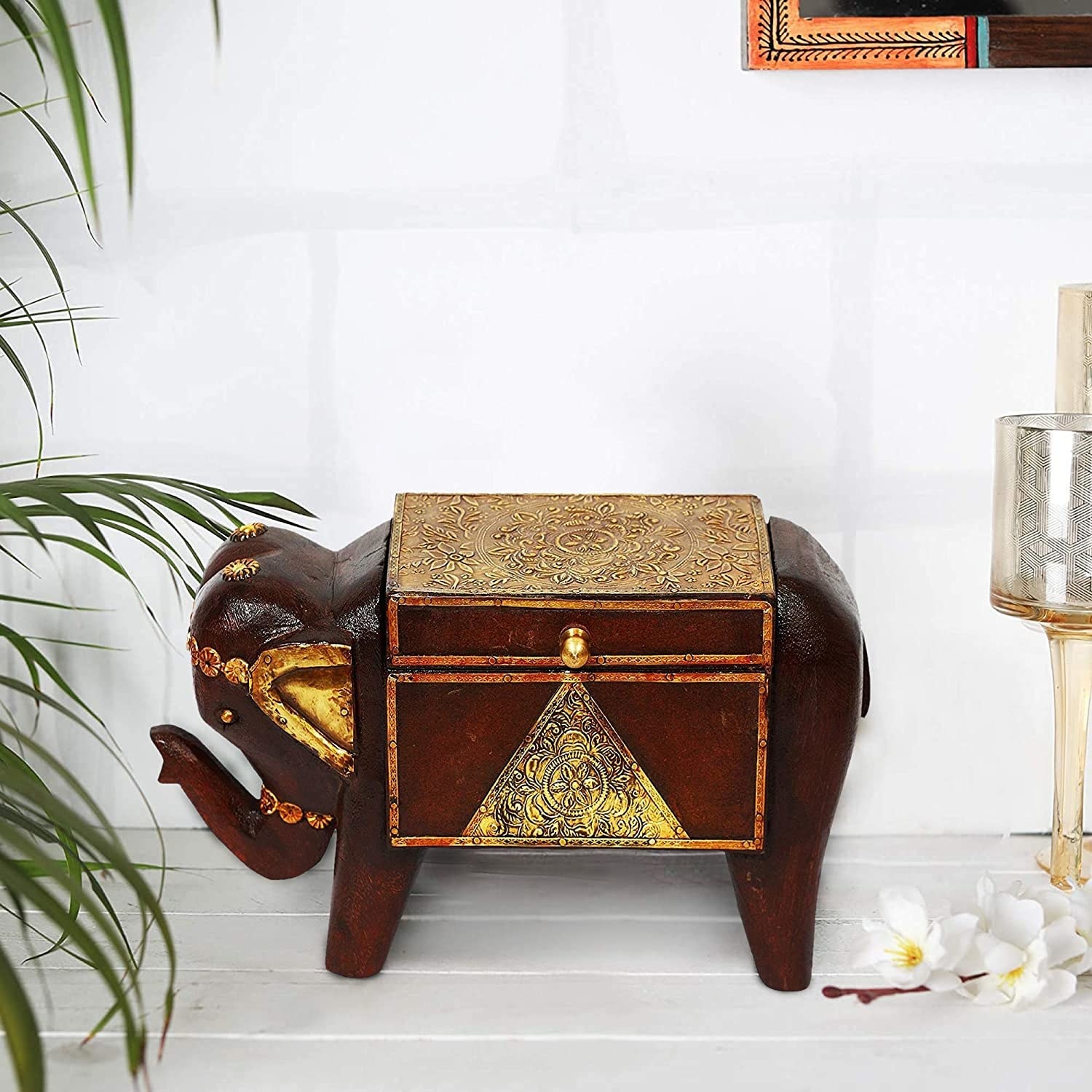 A dark brown and gold elephant -shaped storage box